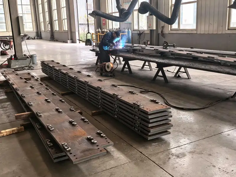 Quality inspector measuring hole position tolerance on steel soleplate using digital caliper